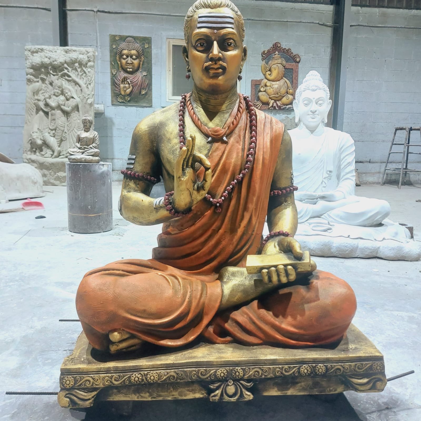 Lord Basava idol statue seated with a vachana tablet in hand